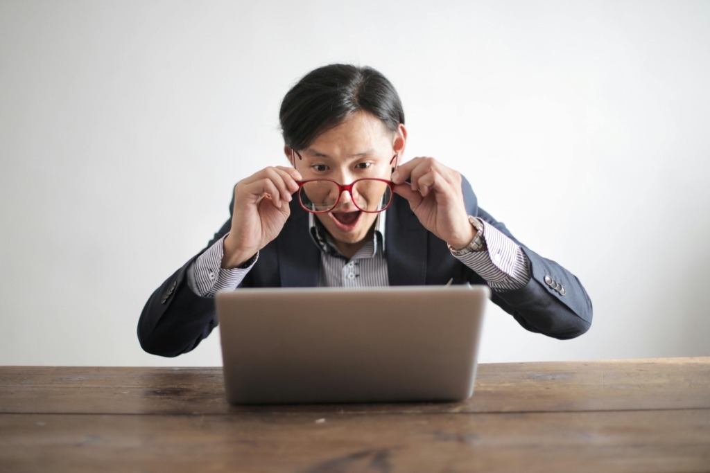 Human resources consulting companies-man looking at computer.